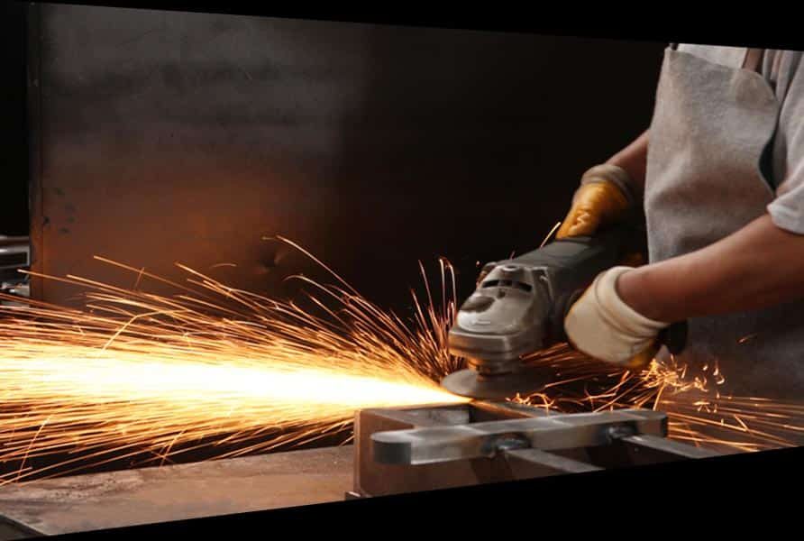 Man Holding Grinder — Structural Steel Fabricators in Rosemount, QLD
